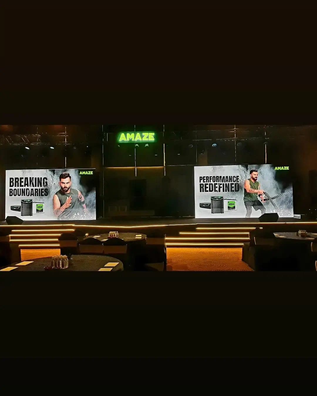 Branded LED video wall stage with warm accent lighting