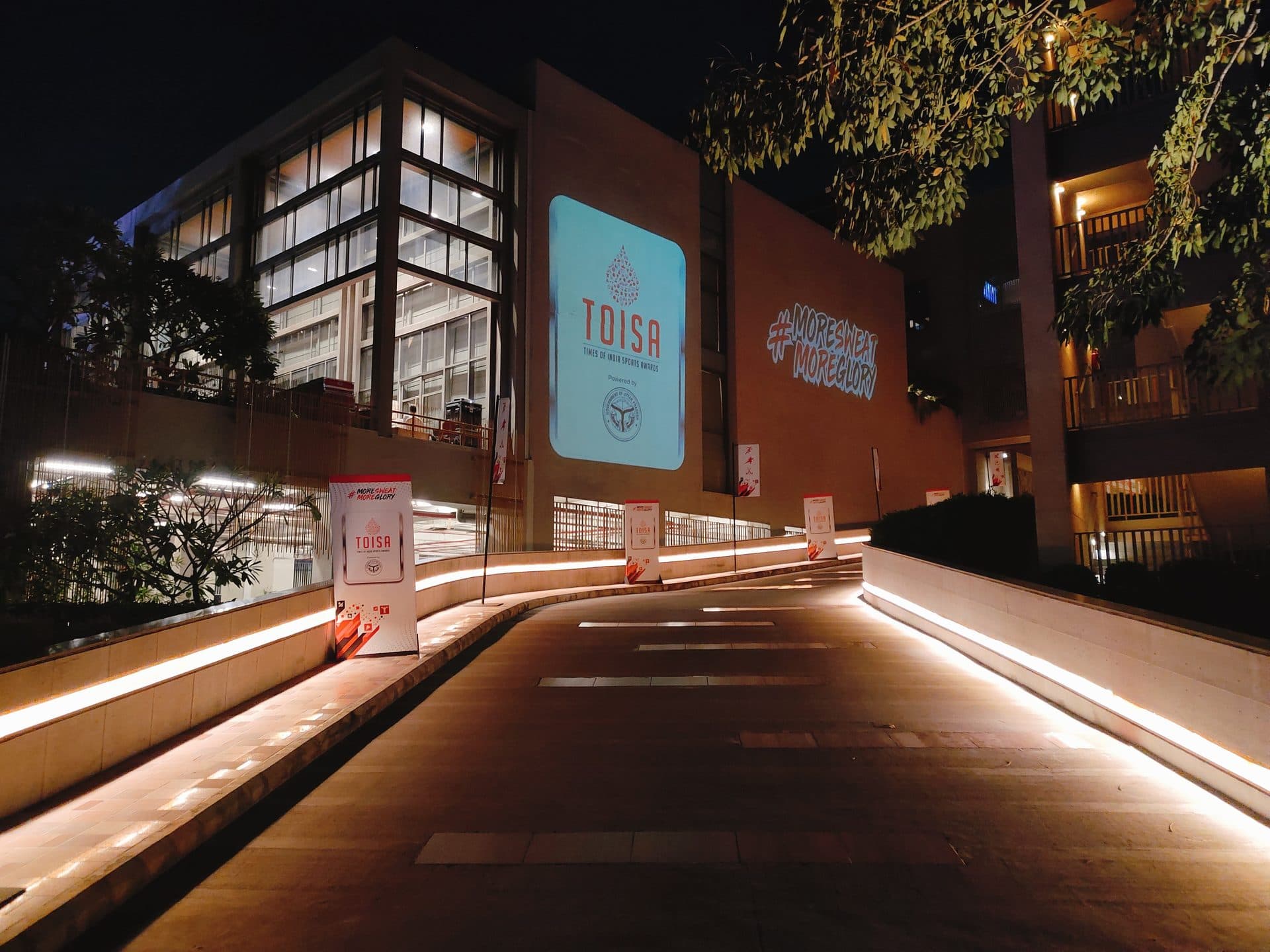 TOISA branded venue driveway with accent lighting at night