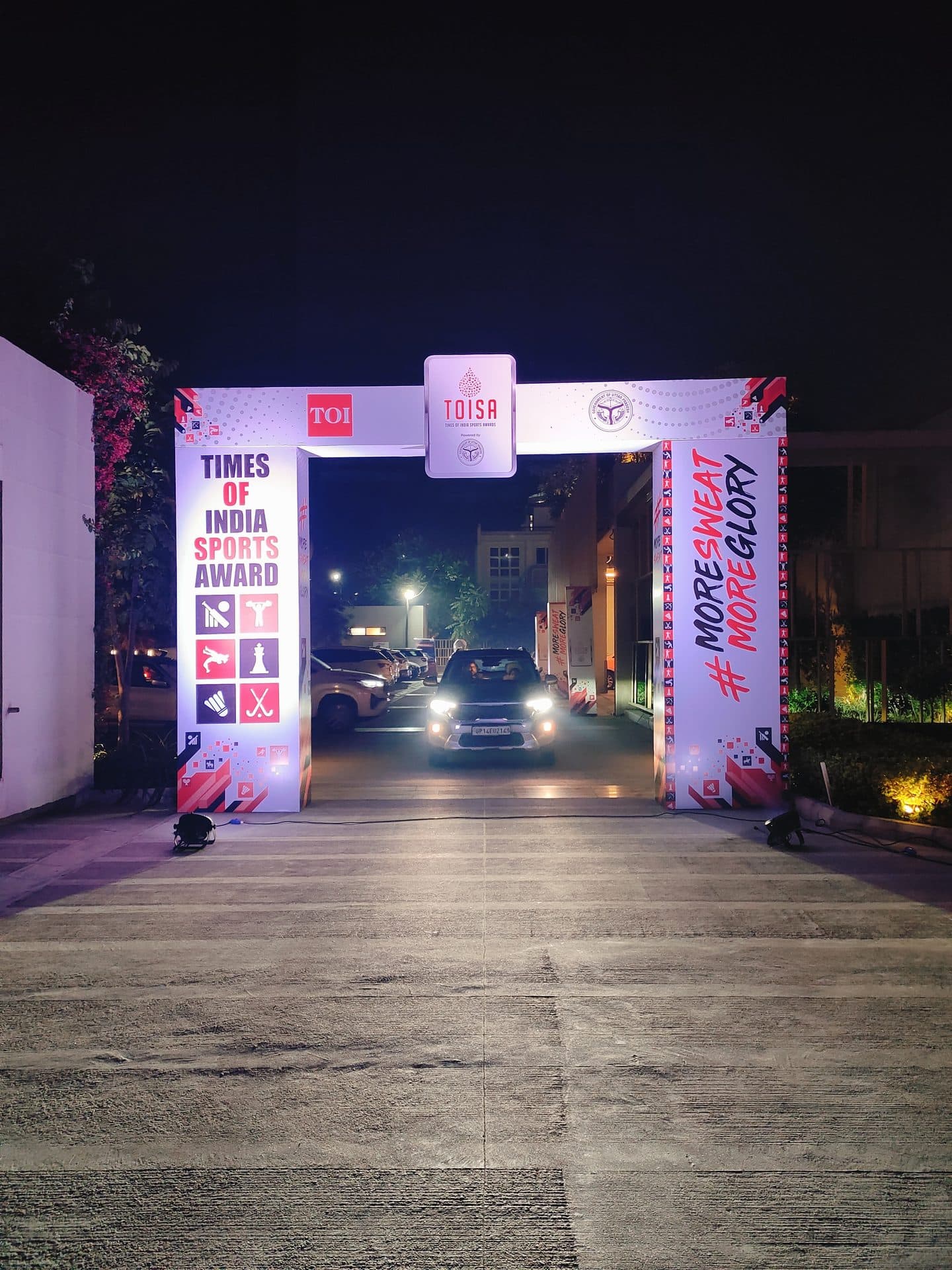 TOISA branded entrance archway at night