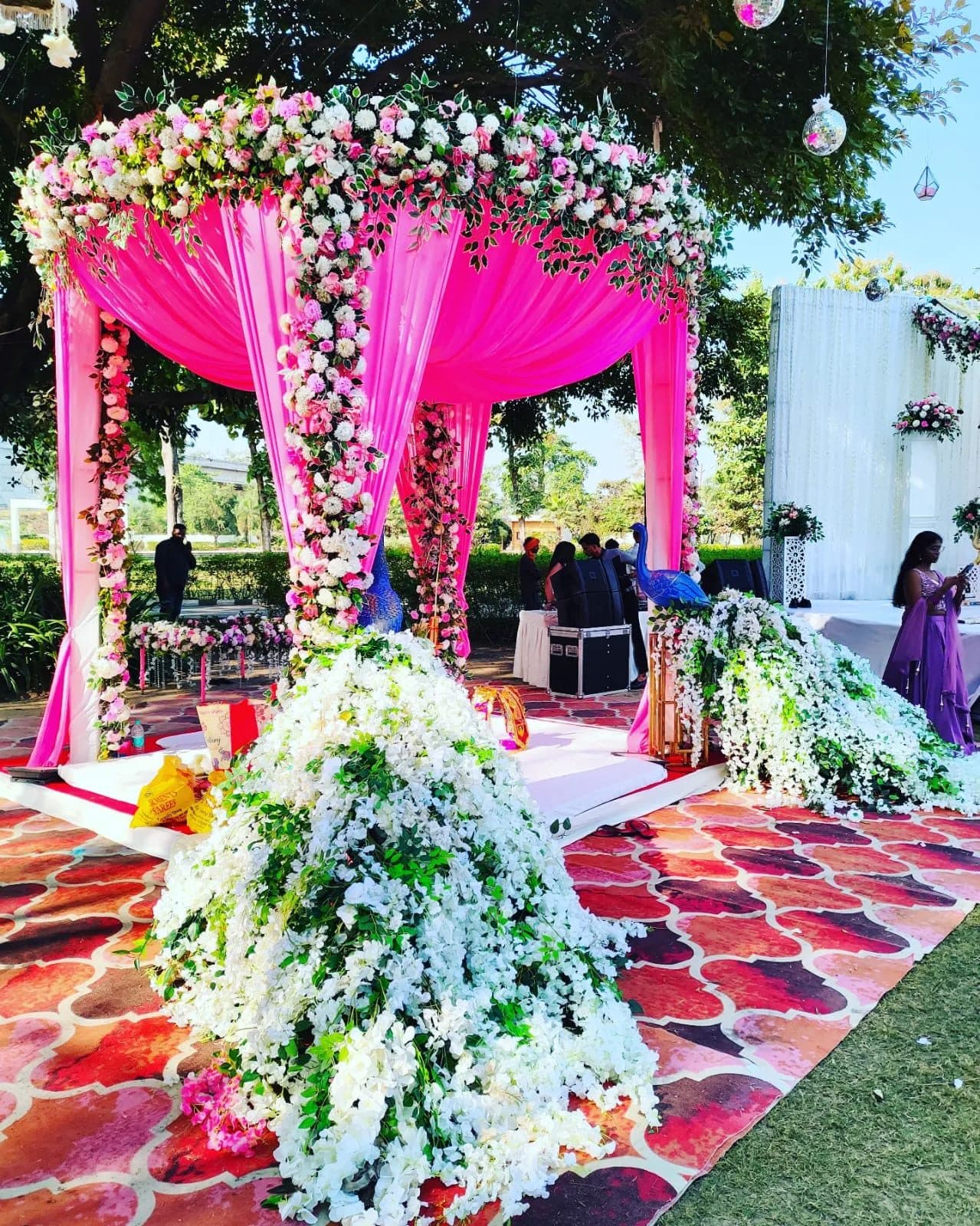Outdoor garden mandap with pink drapery and floral installations
