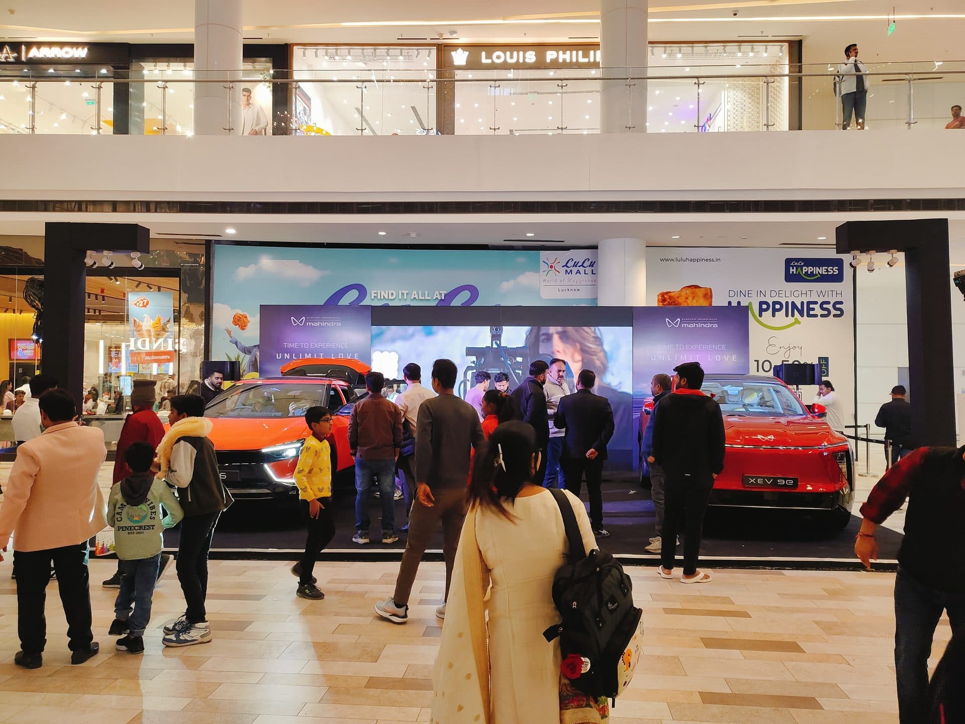 Outdoor exhibition pathway with branded tented stalls